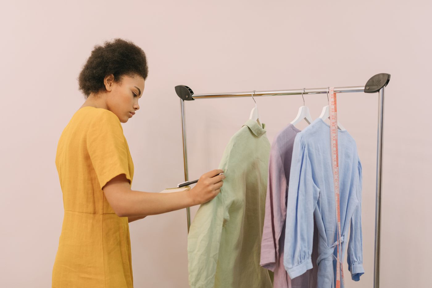 Boutique owner arranging stock on a clothing rail
