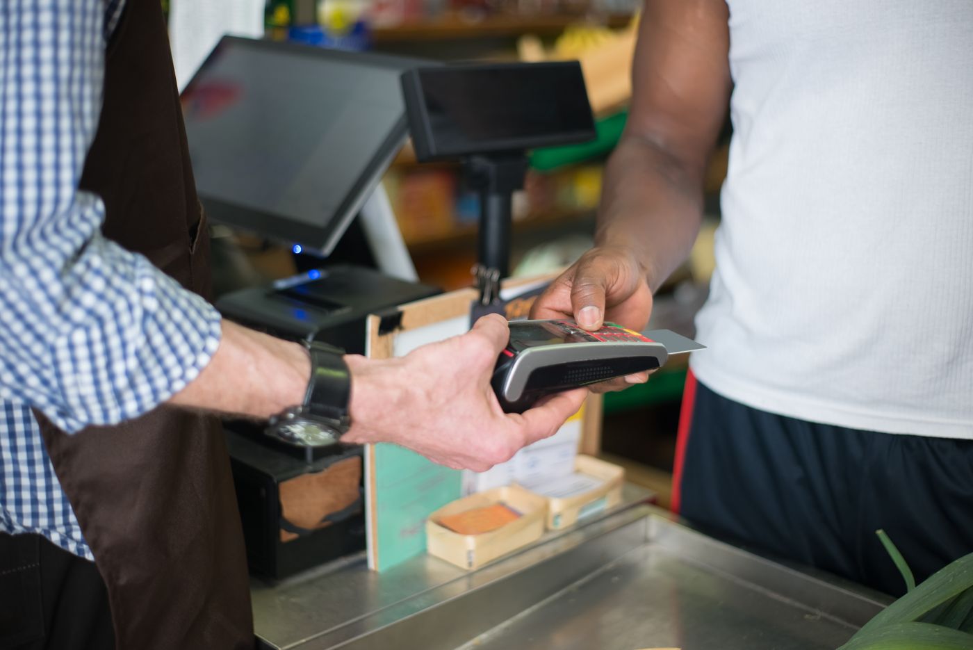 Customer paying by card at a shop counter